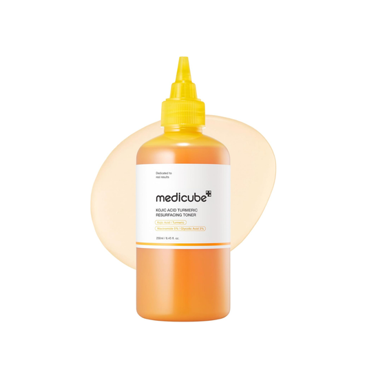 This targeted tone-care toner, MEDICUBE Kojic Acid Turmeric Toner, is made to improve the look of dark spots, shadowy areas, uneven tone, and rough texture. The hygienic nozzle applicator makes it easy to apply directly to areas like underarms, elbows, knees, or anywhere the skin needs brighter, smoother-looking care.

Formulated with Niacinamide, Glycolic Acid, Turmeric Root Extract, Kojic Acid, Allantoin, Panthenol, Ceramide NP, and multiple types of Hyaluronic Acid, it helps support brightening care, gen