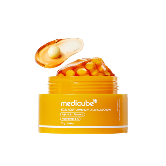 This dual-texture brightening cream, MEDICUBE Kojic Acid Turmeric Vita Capsule Cream, is made to hydrate, smooth, and improve the look of dark spots, dullness, and uneven skin tone. The formula combines vitamin-rich capsules with a clear gel texture, helping deliver radiance care while leaving skin fresh, dewy, and glowing.

Formulated with Kojic Acid, Turmeric Root Extract, Niacinamide, Vitamin C derivatives, Squalane, Panthenol, Allantoin, Ceramide NP, and multiple types of Hyaluronic Acid, it helps suppo